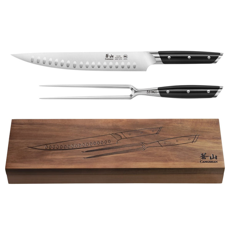 Two-piece carving set with a long serrated knife and a two-prong fork, displayed above a wooden storage box.
