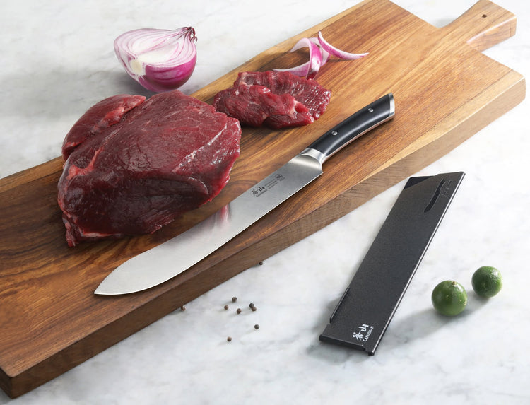 10-inch butcher knife with black handle on wooden cutting board next to raw beef, onion, and knife sheath.