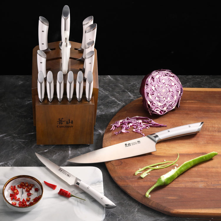 Knife block set with stainless steel knives, one slicing red cabbage on a wooden cutting board, another beside a bowl of chop