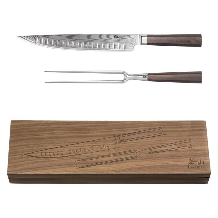 Two-piece carving set with a Damascus steel knife and fork, both with wooden handles, displayed above a wooden storage box.