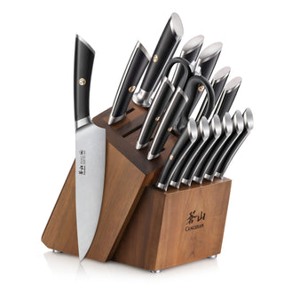 
                    
                      Knife block set with multiple knives featuring black handles and a wooden acacia block holder.
                    
                  