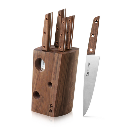 Walnut knife block holding five knives with wooden handles, one chef knife displayed beside it.