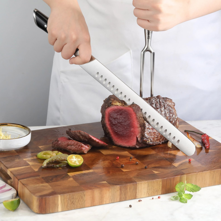 Person slicing medium-rare roast beef on wooden cutting board using a long black-handled knife and meat fork.