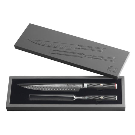 Two-piece carving set with patterned steel blades and dark textured handles in a black presentation box.