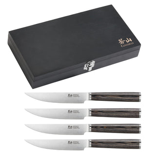 
                    
                      Closed black wooden box with four steak knives featuring stainless steel blades and dark pakkawood handles.
                    
                  