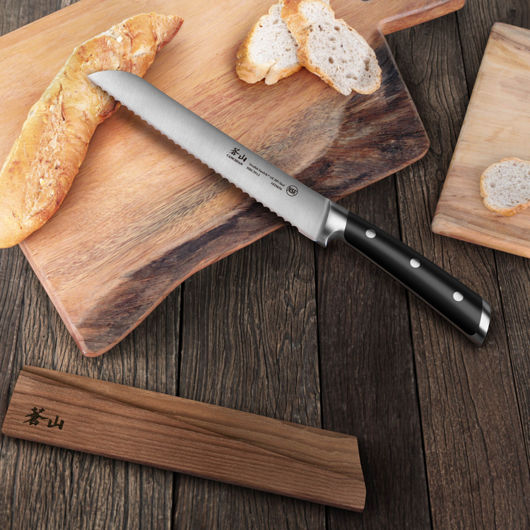 8-inch serrated bread knife with black handle on wooden cutting board next to sliced baguette and wood sheath.