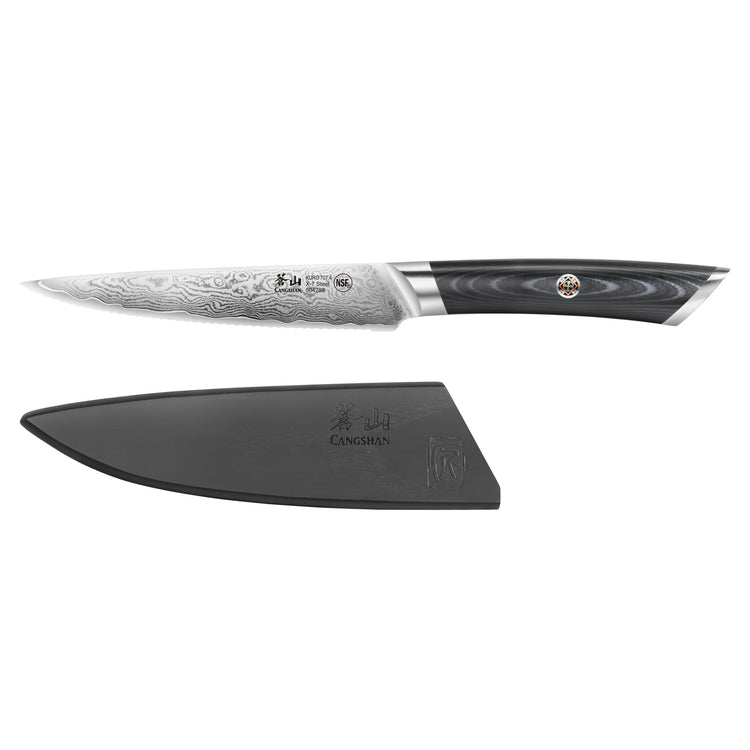 5-inch serrated utility knife with patterned blade and black handle, shown with a black protective sheath.