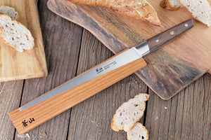 
                  
                    Load image into Gallery viewer, R Series 10.24-Inch Bread Knife with Ash Wood Sheath, Forged German Steel, 62649
                  
                