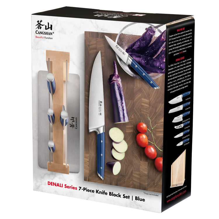 7-piece knife block set with blue handles, including chef's knife, paring knife, and wooden block on a cutting board with veg