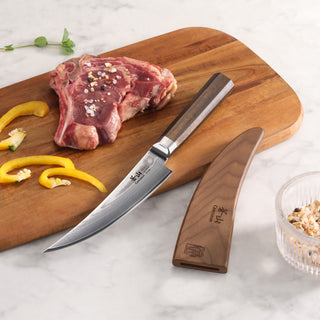 
                    
                      6-inch boning knife with wooden handle and sheath on cutting board next to raw meat and sliced yellow peppers.
                    
                  