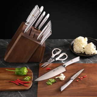 
                    
                      Knife block set with stainless steel knives, kitchen shears, and wooden block on a countertop with chopped vegetables.
                    
                  