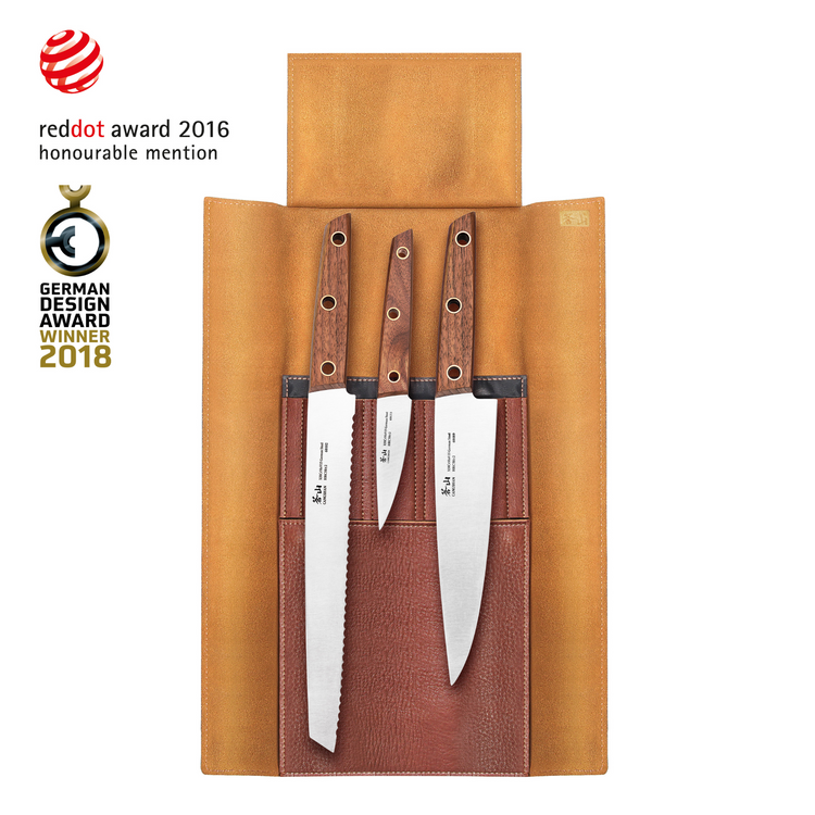 Four knives with wooden handles secured in a tan leather roll-up case with three pockets.