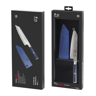 
                    
                      KITA Series 7-inch Kiritsuke knife with hammered blade, blue handle, and matching blue sheath in black packaging.
                    
                  