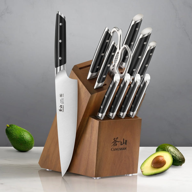 12-piece knife set with black handles in a wooden block, including kitchen shears, displayed with whole and halved avocados.