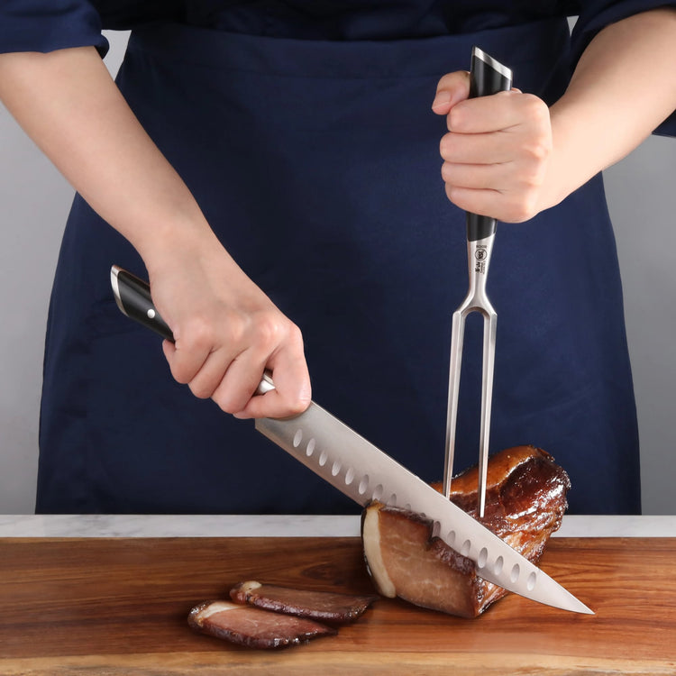 Person slicing a cooked meat roast on a wooden cutting board using a carving knife and fork.