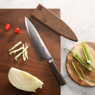 
                    
                      MAYA Series 8-Inch Chef’s Knife X-7 Damascus Steel with a wooden sheath on a cutting board next to sliced vegetables.
                    
                  