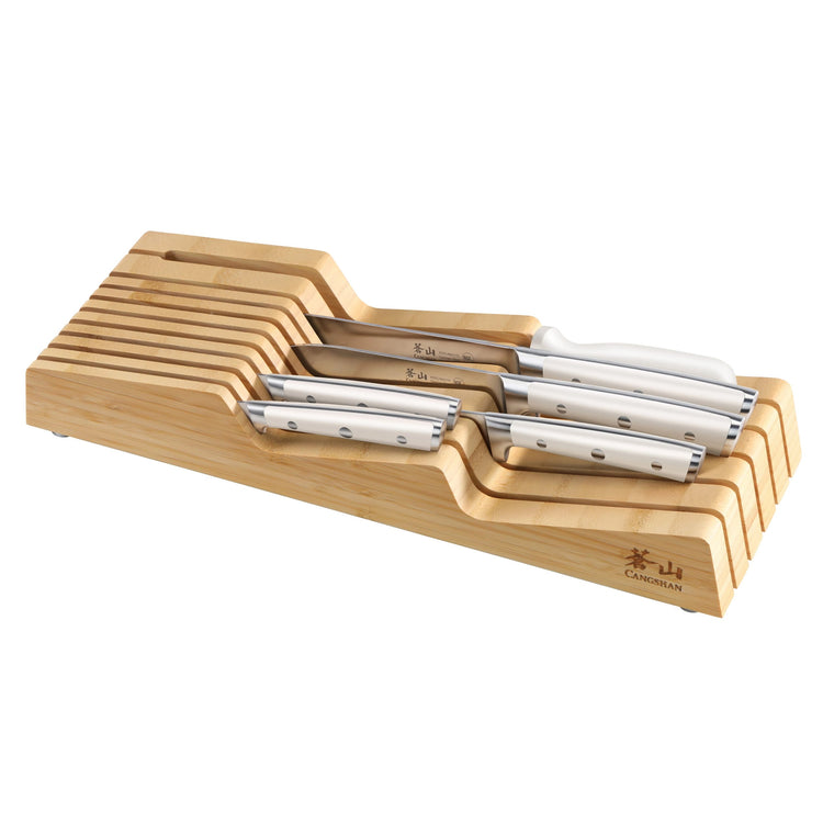 Seven knives with stainless steel blades and riveted handles arranged in a wooden in-drawer knife block.
