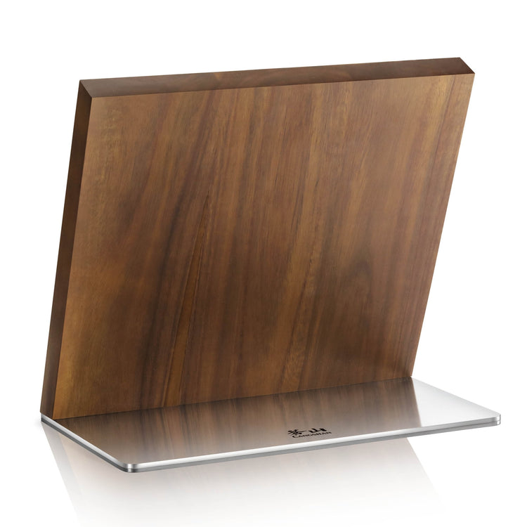 Rectangular wooden magnetic knife block with a stainless steel base, standing upright on a white surface.