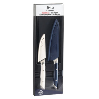 
                    
                      Two-piece knife set with navy and white handles, featuring a utility knife and a paring knife in a black display box.
                    
                  