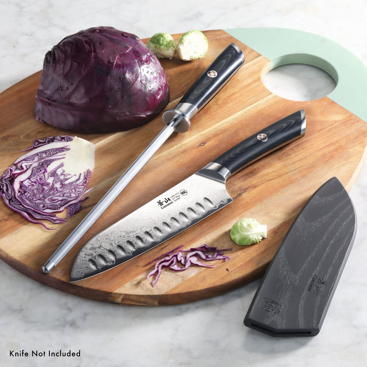7-inch Santoku knife with black handle and sharpening steel on wooden board with sliced red cabbage and Brussels sprouts