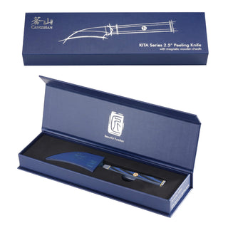 
                    
                      Blue peeling knife with curved blade and sheath, displayed inside an open blue presentation box.
                    
                  