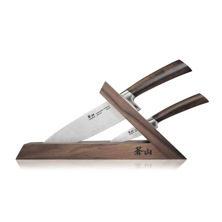 Two knives with wooden handles displayed in a walnut angled knife block with engraved characters.