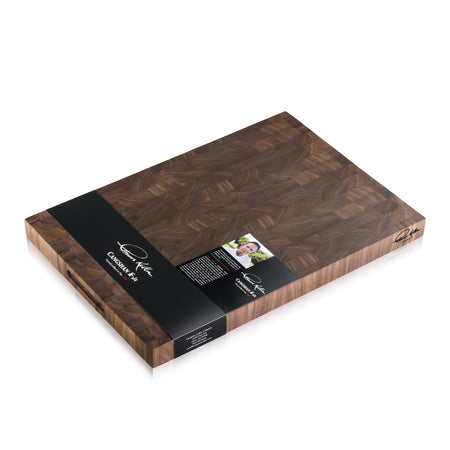 Walnut end-grain cutting board with dark wood pattern and black label from Thomas Keller Signature Collection