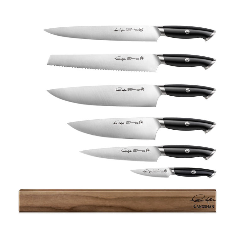 Six knives with black handles and stainless steel blades arranged vertically above a wooden magnetic knife block.