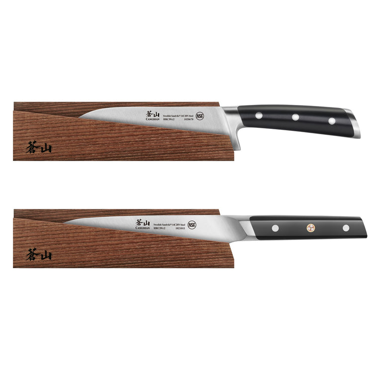 Two kitchen knives with black handles resting on solid ash wood magnetic sheaths with Japanese characters.