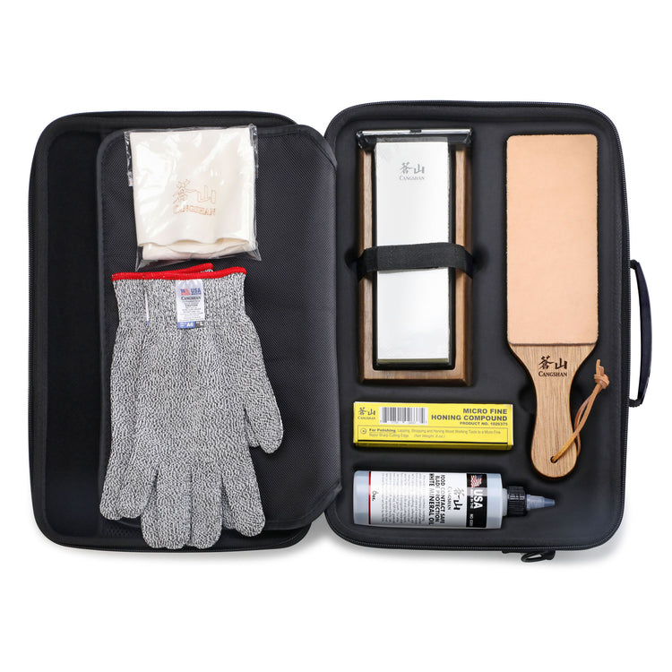 Knife sharpening stone, honing compound, cut-resistant glove, leather strop, and cleaning cloth in a black zippered case.