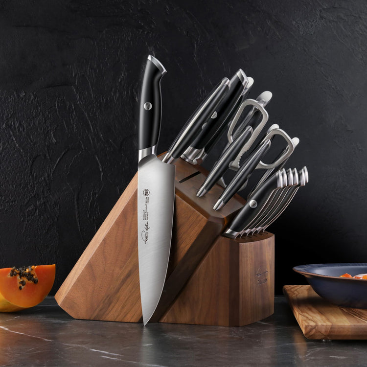 17-piece knife set with black handles in a wooden block, including kitchen shears and steak knives on a countertop.