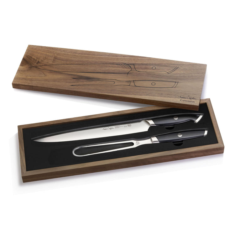 Two-piece carving set with a long carving knife and a fork, black handles, in a wooden box with lid.