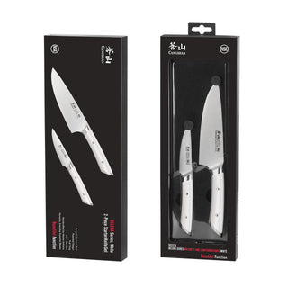 
                    
                      Two white-handled kitchen knives, a chef's knife and a paring knife, displayed in black packaging with product branding.
                    
                  