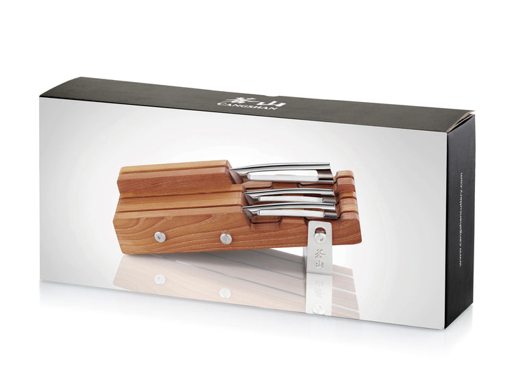 Wooden knife block holding four knives with stainless steel blades and handles, displayed on product packaging.