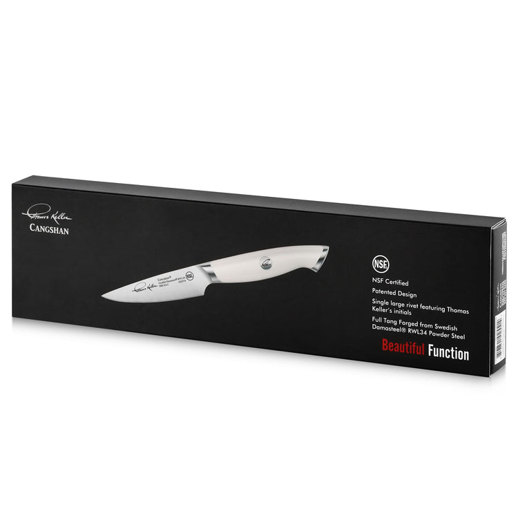 Paring knife with white handle displayed on black rectangular box with product details and branding.