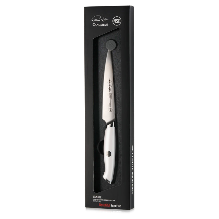 White-handled 5-inch utility knife with stainless steel blade in black packaging from Thomas Keller Signature Collection.
